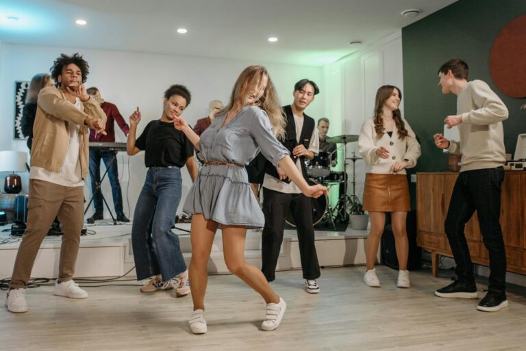 A lively group of friends enjoying a home concert with dancing and live music.